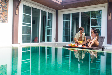 Couple of lovers in a beautiful villa with swimming pool