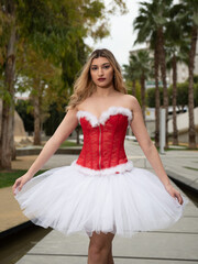 Fototapeta na wymiar Ballerina wearing christmas dress posing outdoors