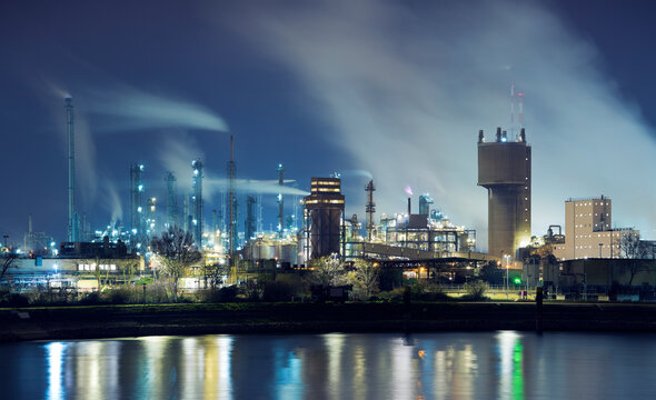 Petrochemical industry factory by a river at night