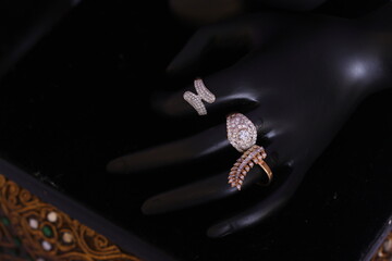 stone studded diamond ring on a hand mannequin