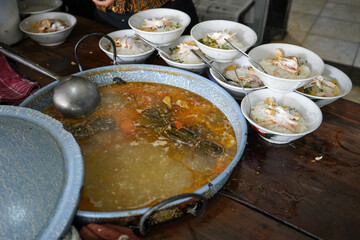 Central Java, Indonesia - August, 2021 : Soto Gading is a very famous chicken soup in the city of Surakarta. Many businessmen, officials and presidents like this chicken soup. © Faris Fitrianto