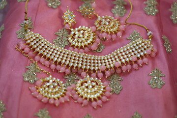 kundan style choker set on a pink lehenga