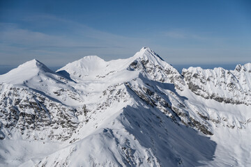 Fototapeta na wymiar snow covered mountains, Iezerul Caprei, Vaiuga and Buteanu Peak, Fagaras Mountains, Romania 