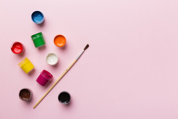 art palette with paint and brushes, close up. Top view with empty space. workplace for creativity. home teaching concept drawing