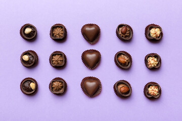 Different kinds of chocolates on colored table close-up. Top View and Flat Lay