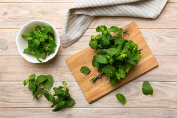 Fresh mint on Cutting board table, top view. Flat lay Space for text