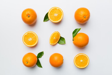 Fruit pattern of fresh orange slices on colored background. Top view. Copy Space. creative summer concept. Half of citrus in minimal flat lay