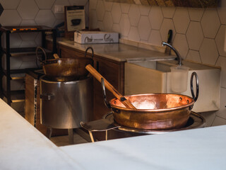Copper saucepan in open kitchen of restaurant.