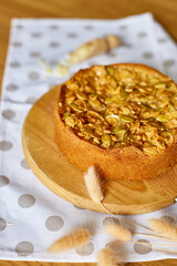 Apple or pear pie, tart with caramel nuts on wooden table, copy space, top view.