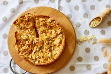 Apple or pear pie, tart with caramel nuts on wooden table, copy space, top view.