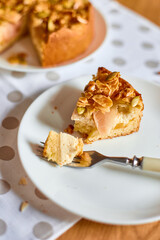 Piece of apple or pear pie, tart with caramel nuts on wooden table, copy space, top view.