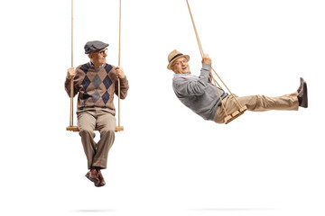 Elderly man sitting on a wooden swing and looking at another man swinging