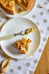 Piece of apple or pear pie, tart with caramel nuts on wooden table, copy space, top view.