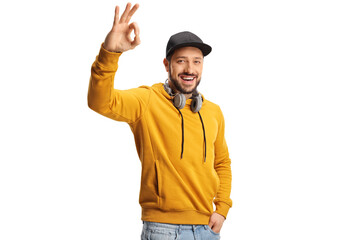 Smiling young man with headphones gesturing ok sign