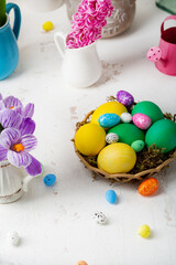 Fototapeta na wymiar Flowers and Easter eggs on light table
