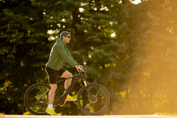 Young man riding ebike in nature