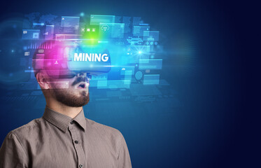 Businessman looking through Virtual Reality glasses