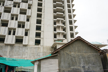 High-rise hotel or apartment buildings are a residential solution for people who live and work in big cities that are very densely populated and land is very expensive.