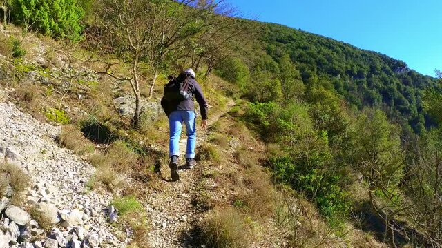 boy while practicing mountain walk taken from behind
