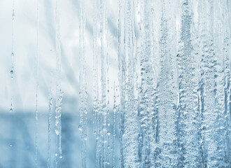 Frozen glass. Winter ice pattern on frozen window. Frozen water on the window glass - 482195081