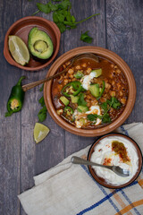Poblano hominy bowl- vegetarian mexican lunch. Served with cream, avocado, sliced jalapenos.