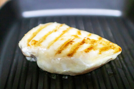 Whole Grilled Chicken Breast With Grill Marks In Pan.