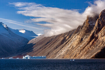Late afternoom sunlight of the mountains in Franz Joseph Fjord on the east coast of Greenland. This...