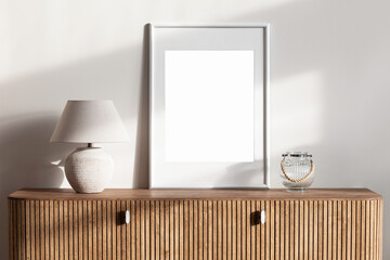 Blank picture frame mockup on white wall. Template for painting or poster. White living room interior design. View of modern rustic style interior with artwork mock-up © kite_rin