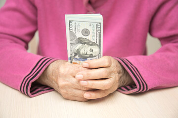 Senior mature business woman holding pack of us dollars. Closeup of money and hands. selective focus - 482197602