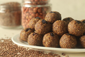 Flax seed peanut laddu. Indian sweet made with coarsely ground flax seeds and groundnuts with freshly grated coconut and jaggery, flavoured by cardamom