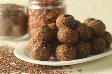 Flax seed peanut laddu. Indian sweet made with coarsely ground flax seeds and groundnuts with freshly grated coconut and jaggery, flavoured by cardamom