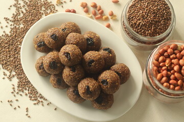 Flax seed peanut laddu. Indian sweet made with coarsely ground flax seeds and groundnuts with freshly grated coconut and jaggery, flavoured by cardamom