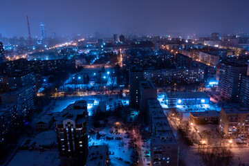 Top view of the roof of night newly built business center inmodern residential quarter with futuristic illumination.