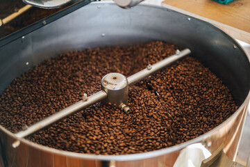 The process of roasting coffee beans. Coffee beans being roasted in a roasting machine. 