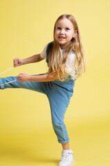 European baby girl with blonde hair isolated on yellow