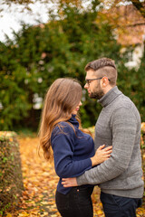 Fototapeta premium Tender young european married couple in park in fall