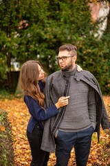 Fototapeta premium Caring young european married couple in autumn park