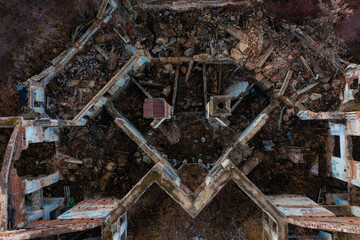 vertical downward view of the walls of an abandoned and destroyed building, the smooth geometry of architecture as pattern, bird's-eye view from a drone.