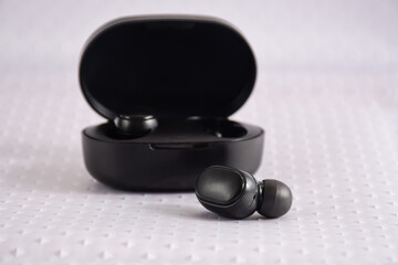Black true wireless earbuds with power bank case, wireless lifestyle - obrazy, fototapety, plakaty
