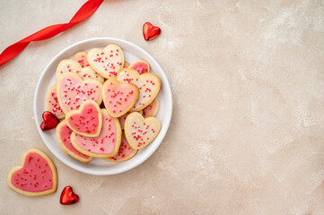 Heart cookies. Homemade butter cookies with pink glaze and sprinkles. Top view. Copy space