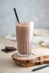 Chocolate protein drink in glass for nutrients and energy, fitness drink