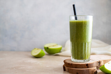 Green apple banana smoothie in glass with paper straw. Healthy lifestyle, dieting and detox.