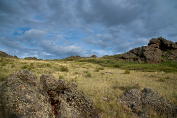 The landscape of rocky hills in summer. Cloudy summer day. The concept of nature - 482201480