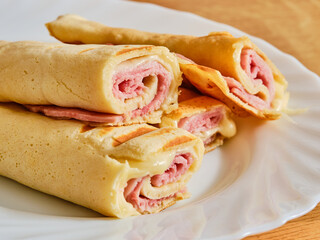 Pancakes with ham and cheese on plate