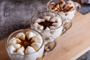 Assortment of mini chocolate and nuts desserts in the glass. Mini choloate desserts on a rustic background