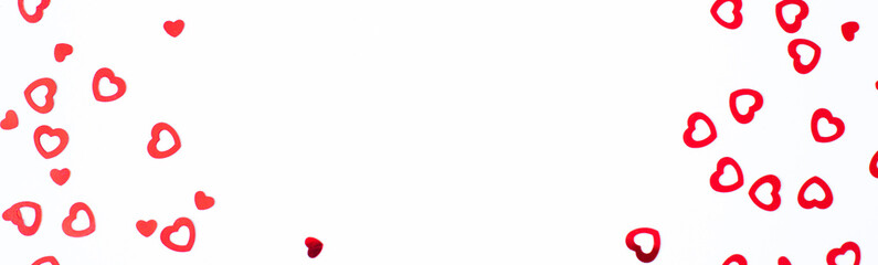 Valentine's Day background February 14th. Red hearts confetti on white background. Valentines day creative concept. Flat lay, top view, copy space.