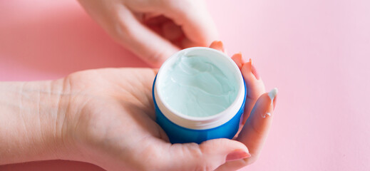 Close-up of a woman applying a protective cream on her hands. Protection of the skin of the hands in the cold or sun season. Beautiful female hands. Female Hands Applying Cream, Lotion. Hand skin care