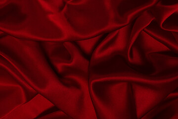 Rich and luxury red silk fabric texture background.