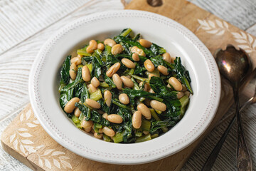 Chicory  leaves and Cannellini Beans or Cicoria e fagioli, south Italian vegan salad.