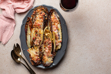 Baked red Radicchio with Bacon, bechamel, pine nuts and parmesan cheese. Red wine. Italian food. Copy space.